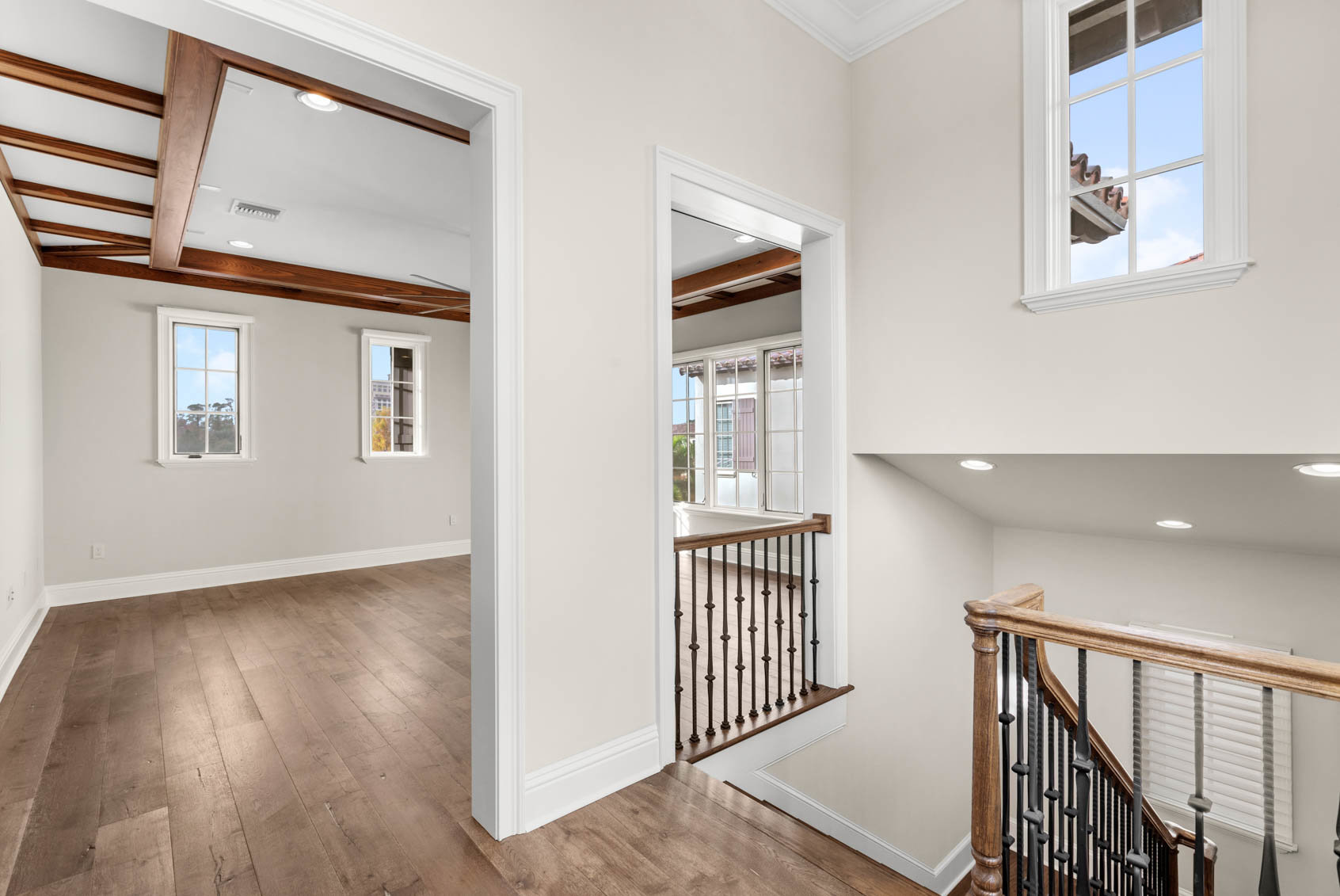 upstairs with railing and entry to family room